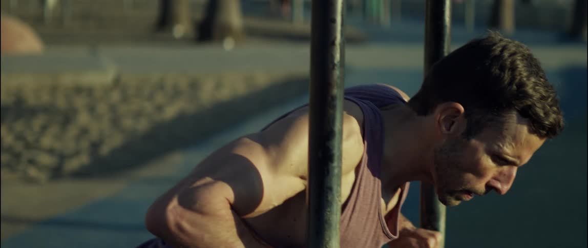 A man is doing pushups in the park