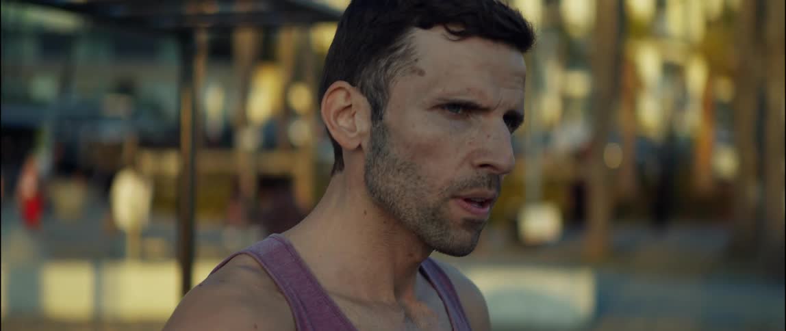 A young man is working out outdoors in the summer time