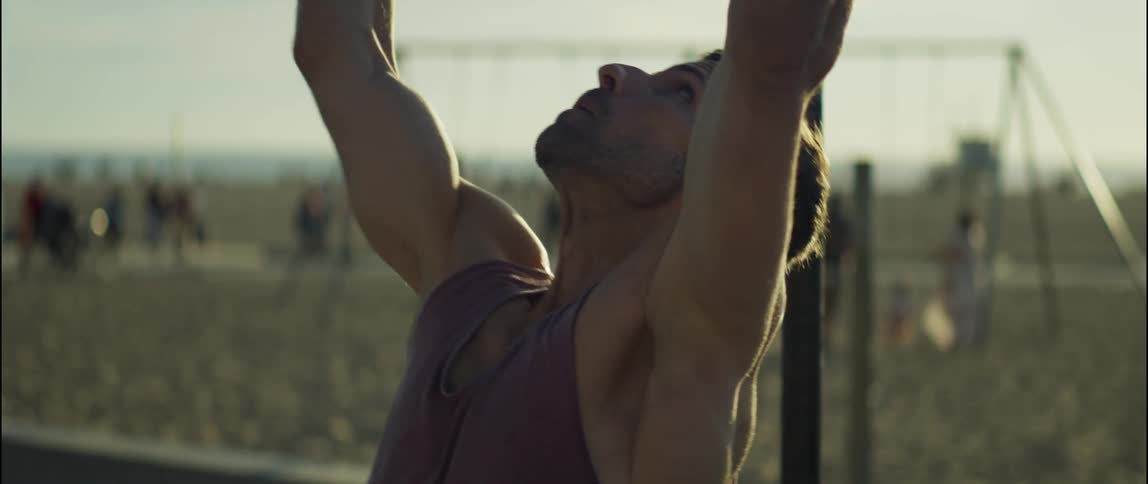 A man is exercising on the beach during the sun set