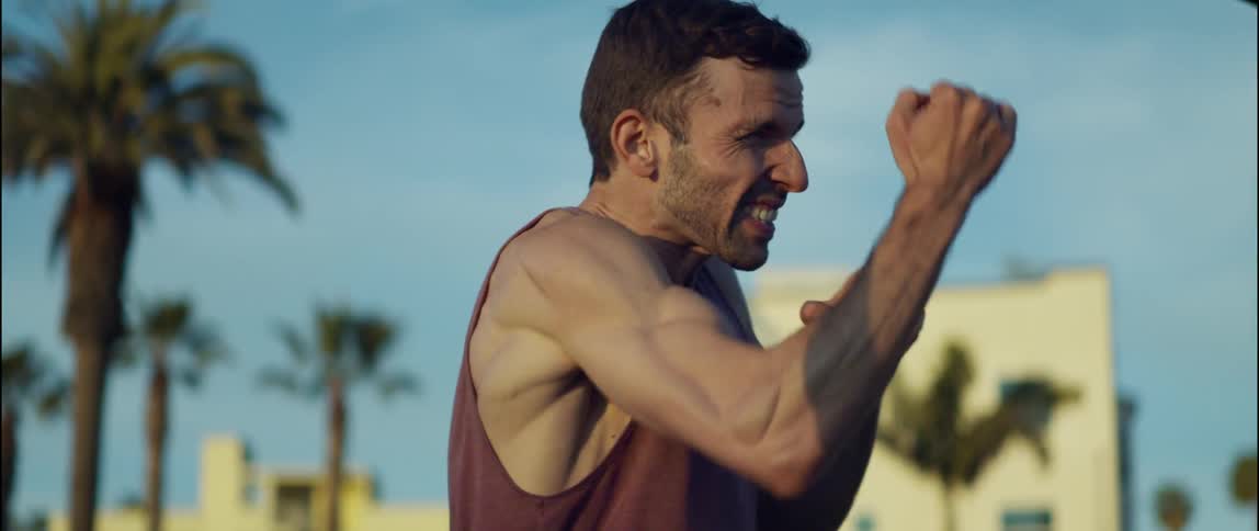 A man is exercising outdoors during the daytime