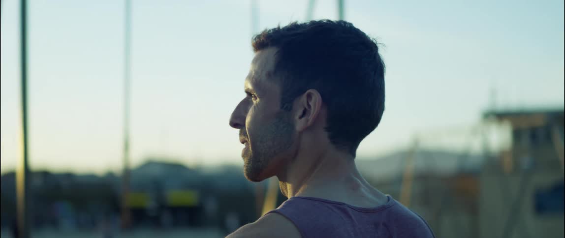 A man is working out outdoors in the middle of the day