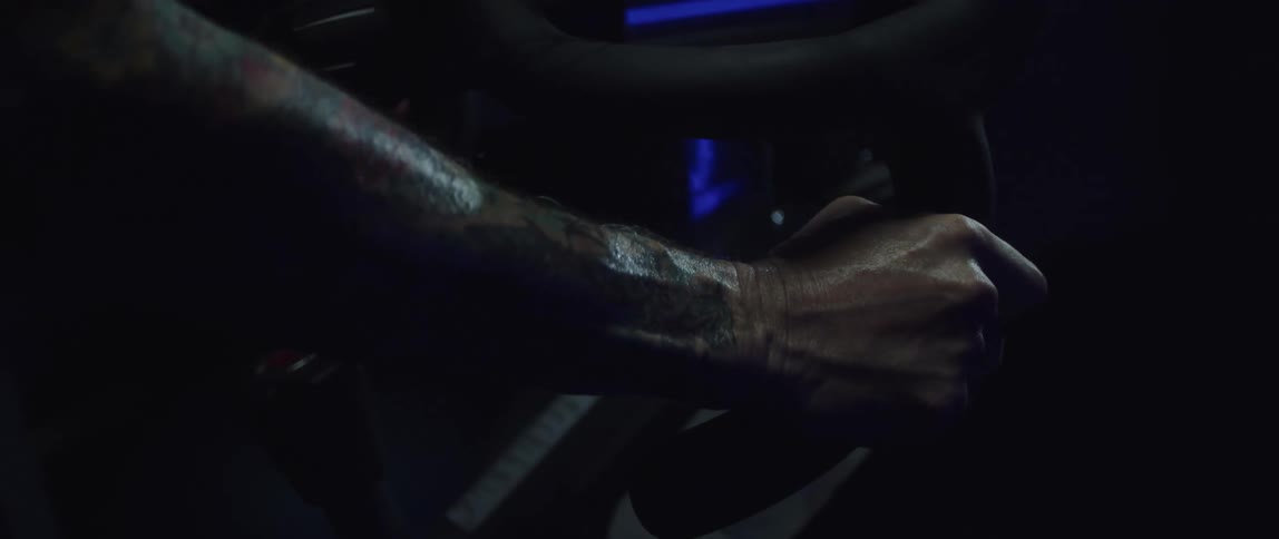 A person holds the handles on the exercise bike