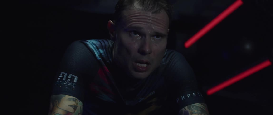 A man sweats as he exercises on a stationary bike
