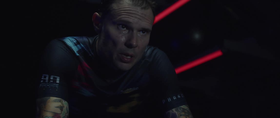 A man is sweating as he uses an exercise bike