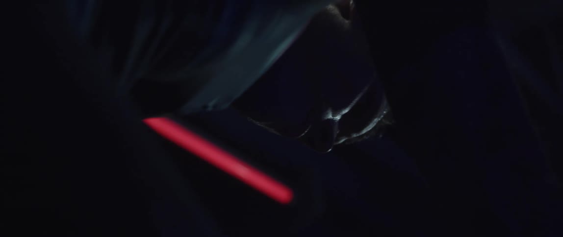 A man riding a stationary bike in a dark room