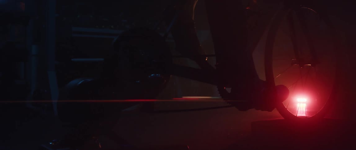 A person is sitting on a stationary bike