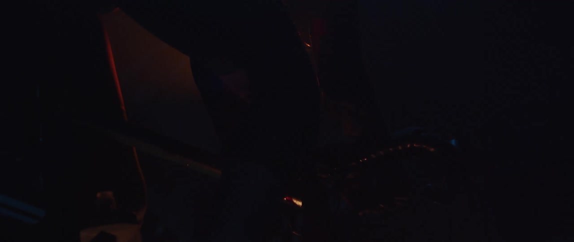 A man riding a stationary bike in front of a bright light