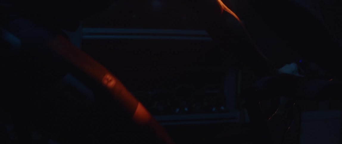 A man riding a stationary bike in a dark room