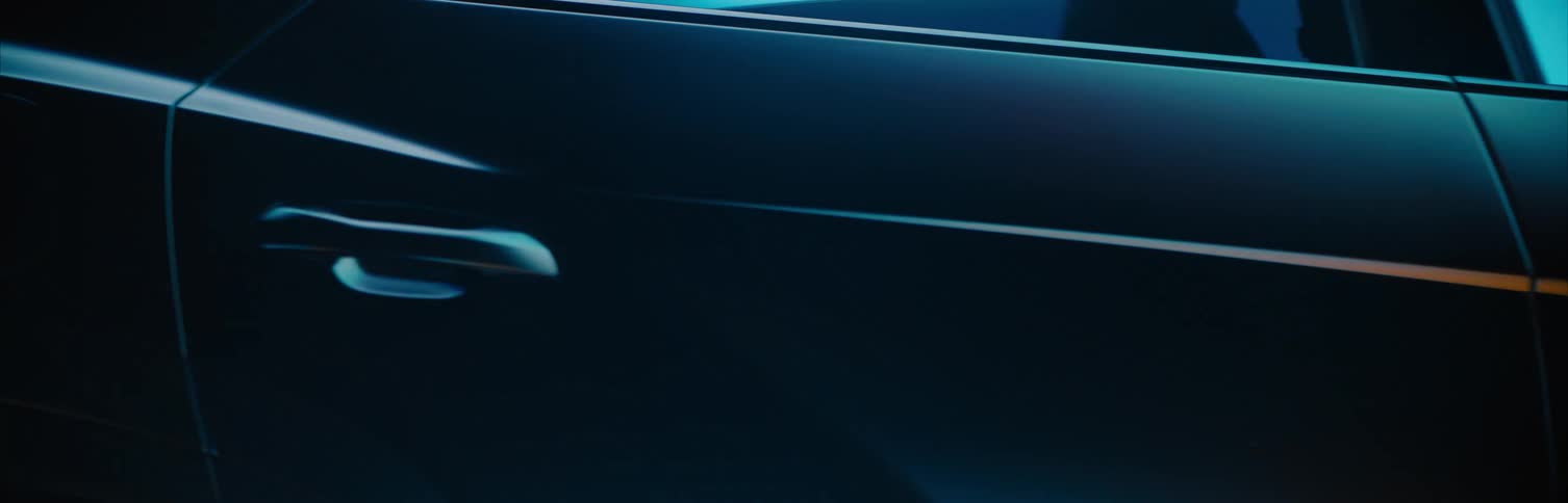 The side of a car is shown with a colorful background