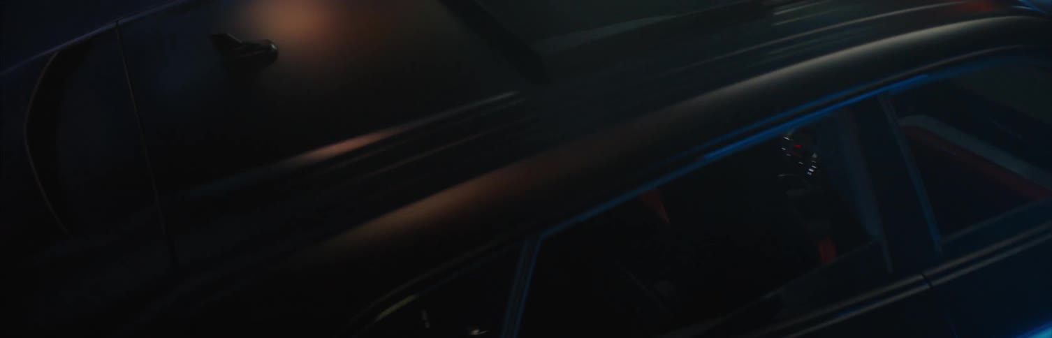 Colorful lights shine on a vehicle as it speeds through a tunnel