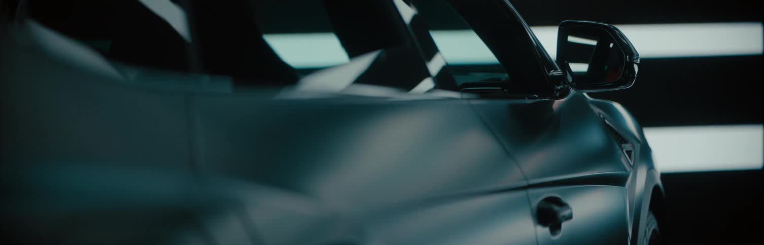 A sports car is parked near blinds that open and close