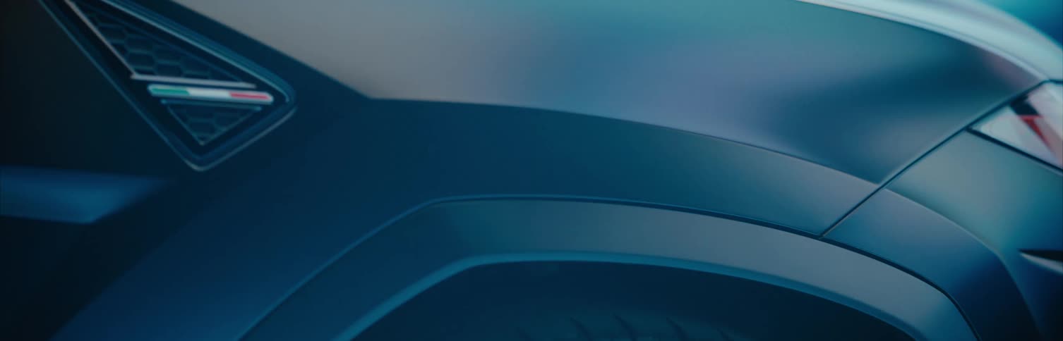 A futuristic car is displayed in front of flashing colorful lights