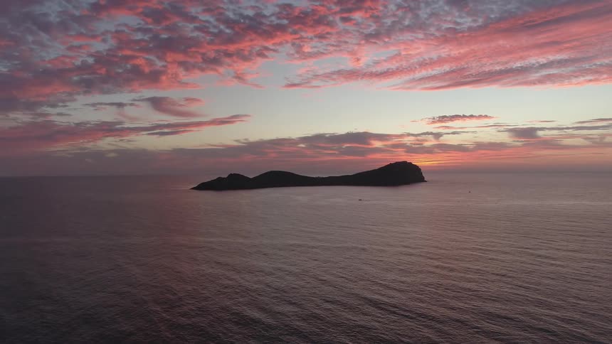 A small island sits in the middle of the sea