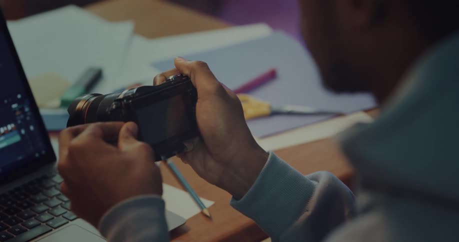 Man pulls sd card from camera and inserts it in a laptop