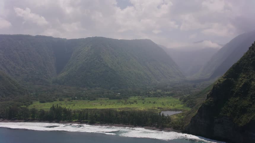 Fog covers valley and mountains bordering ocean