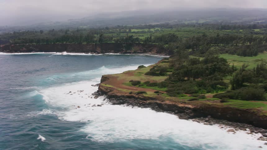 Aerial view of the headland and low cliffs of a coastline close to the ocean