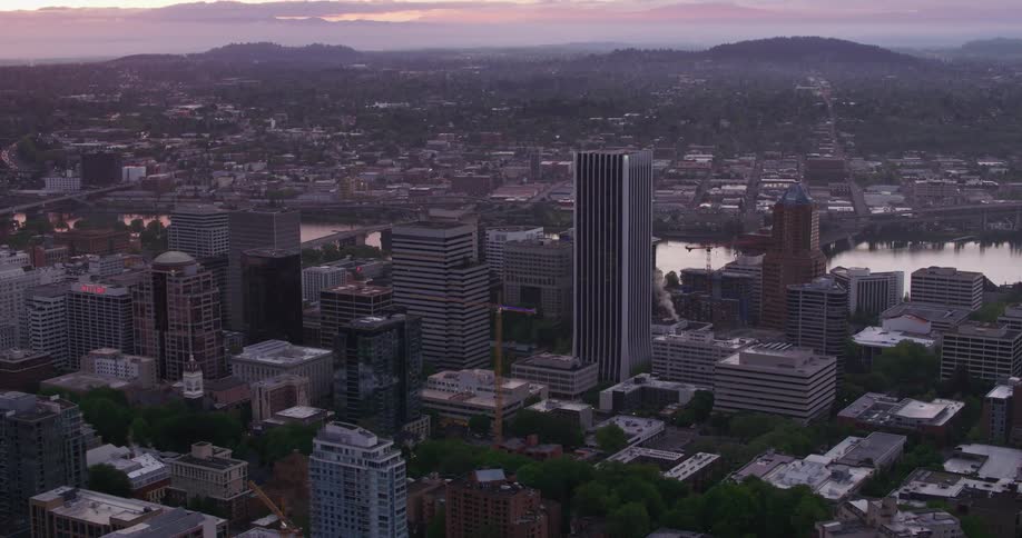An aerial view of a river running behind high rise office buildings in a city
