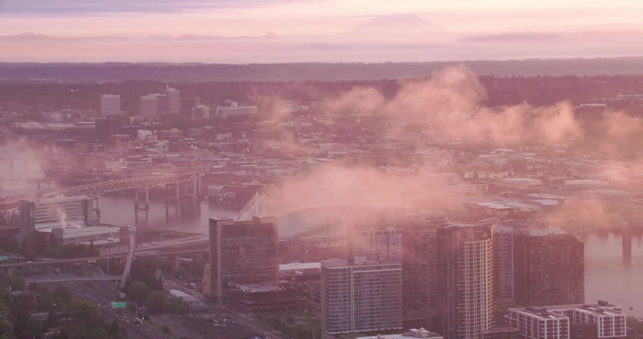 Heavy smog moves over a river running through downtown