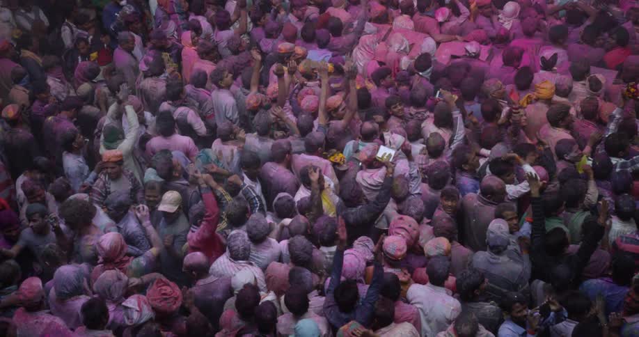 A crowd of people packed together for a holi celebration