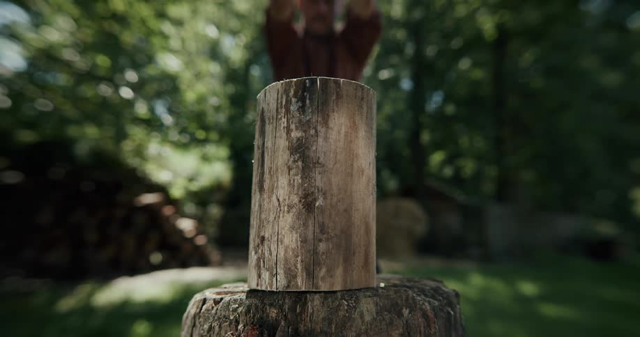 A man splits a log with an ax
