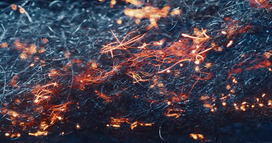Bright yellow sparks flaming through a mesh of fabric