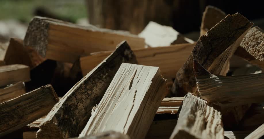Pieces of chopped wood falling over a pile after being splitted