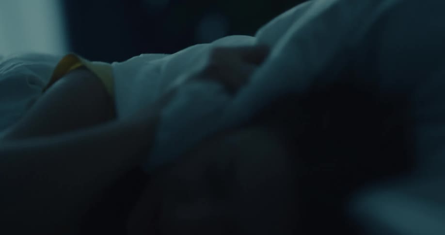 A woman tosses and turns in bed