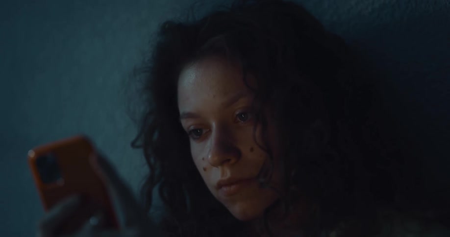 A sleeping woman wakes up and immediately checks her phone