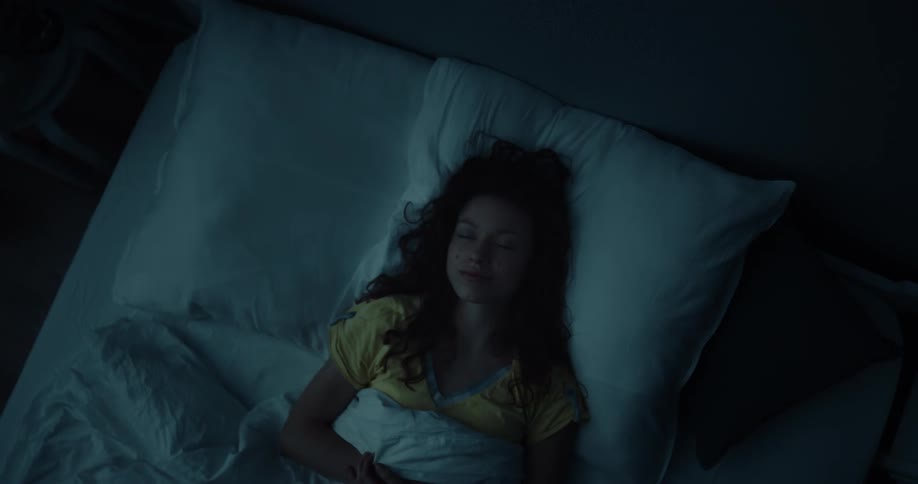 A woman is laying in bed sleeping