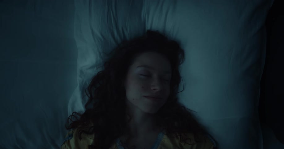 A woman is resting in bed