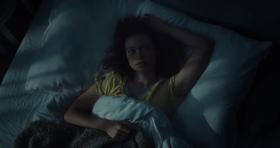 A woman is resting in bed