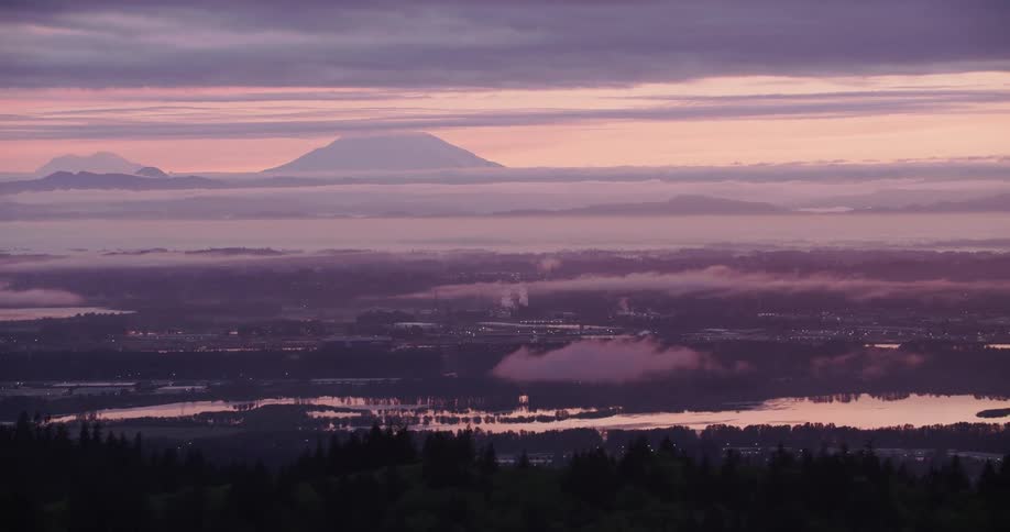 A view of a sunset with a mountain in the distance