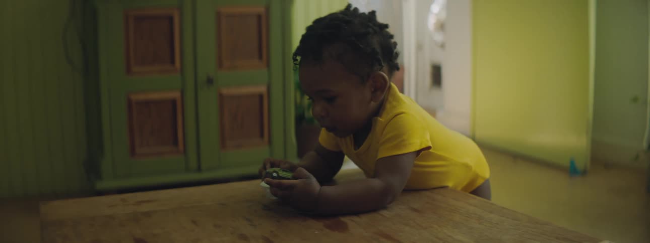A toddler playing with toy cars at home
