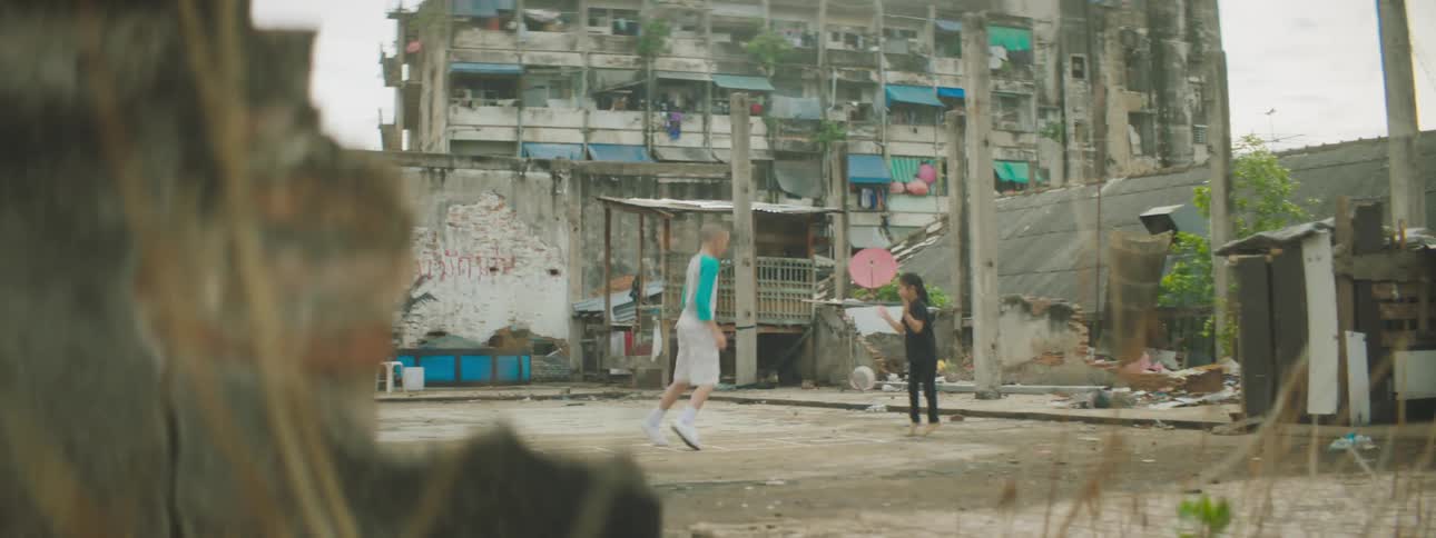 A young boy and girl in an under developed country play outside