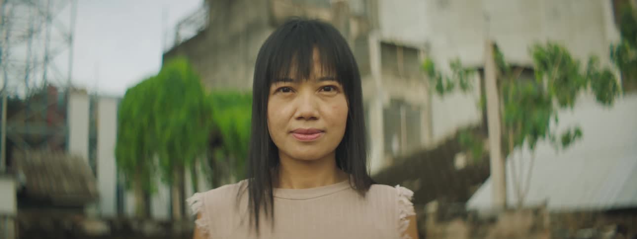 A woman is standing outdoors during the spring