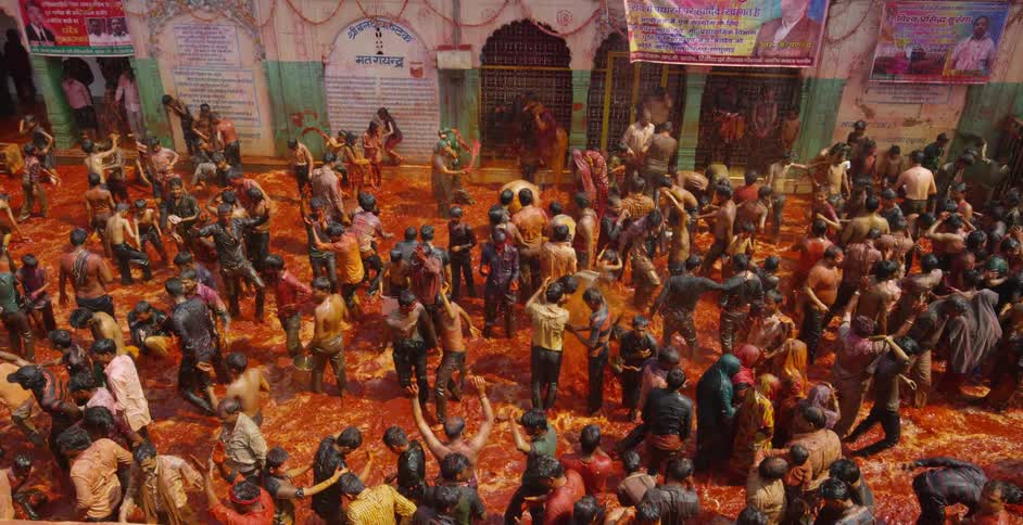 People dance and cheer in the water below