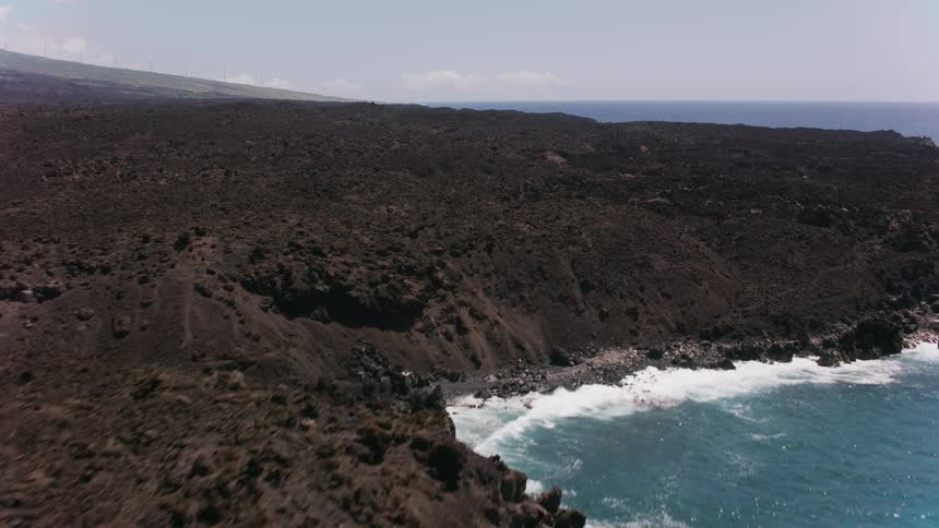 An aerial view of waves crashing in to the shore