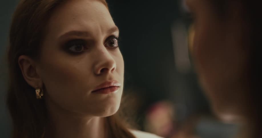 A woman approaches another in a doorway looking angry and confused