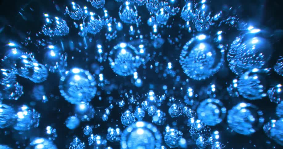 Light shines on blue spheres moving around in reflective darkness