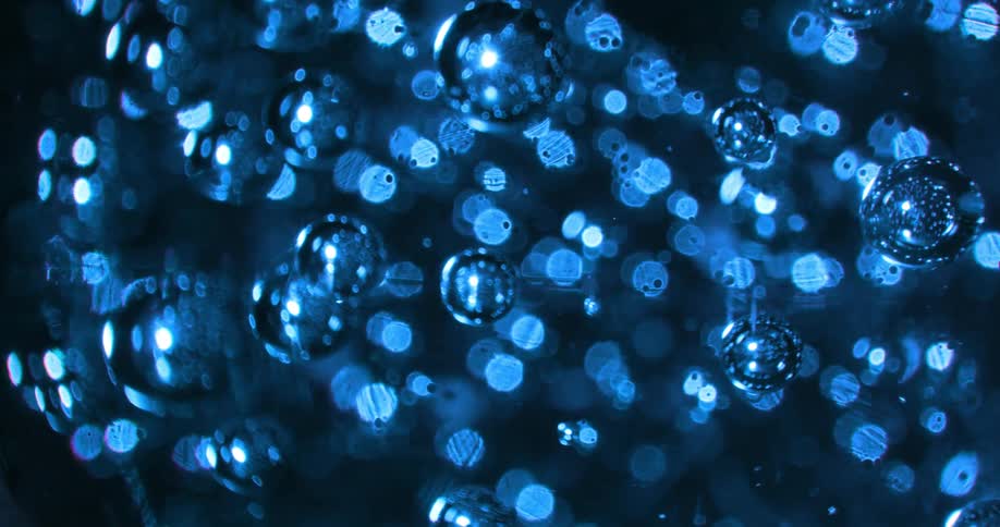 Shiny blue spheres are moving with blue circles of light