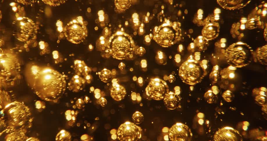 Numerous bubbles are embedded within an amber glass sphere