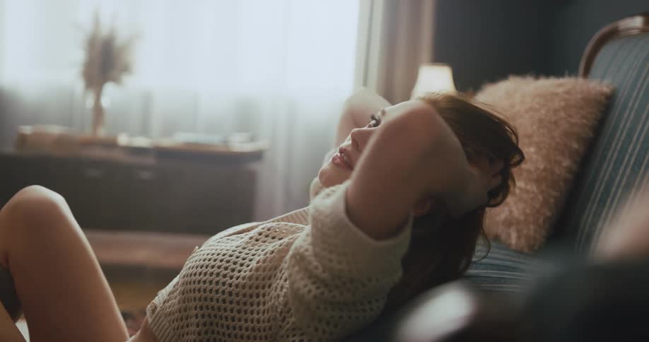 Redheaded woman stretches and smiles then poses for the camera