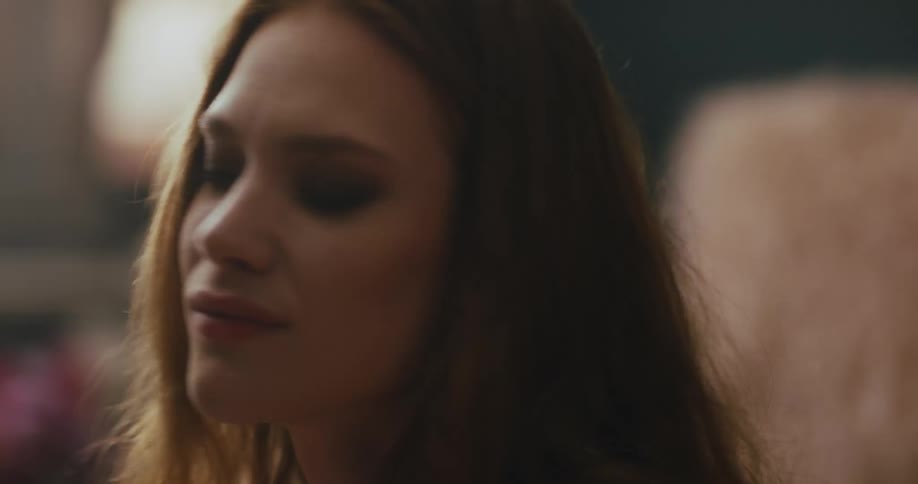 A teenage girl dances at home