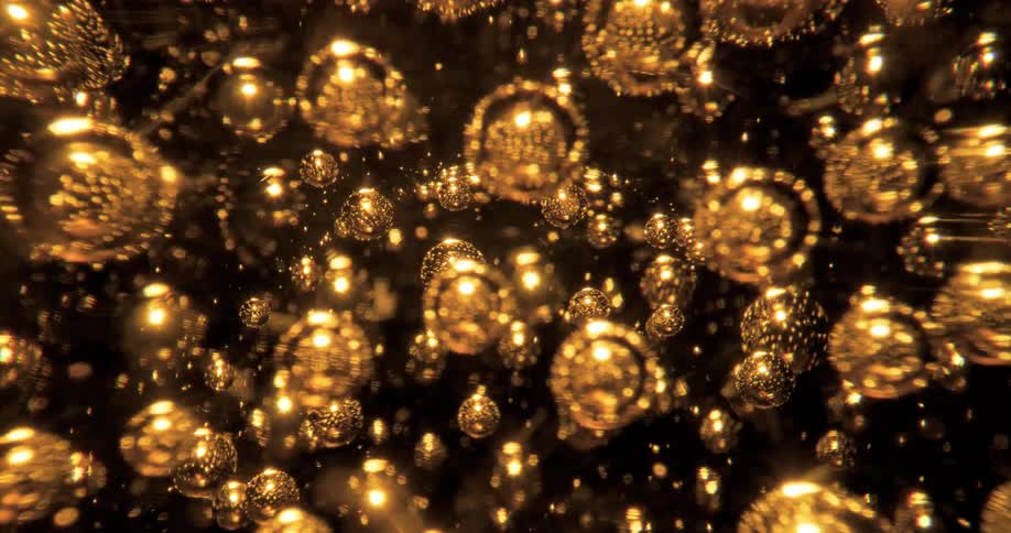 Gold spheres rotating and shimmering reflecting light
