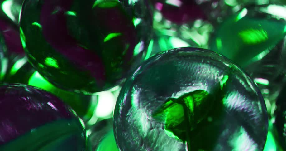 A bright light shines through a container full of marbles