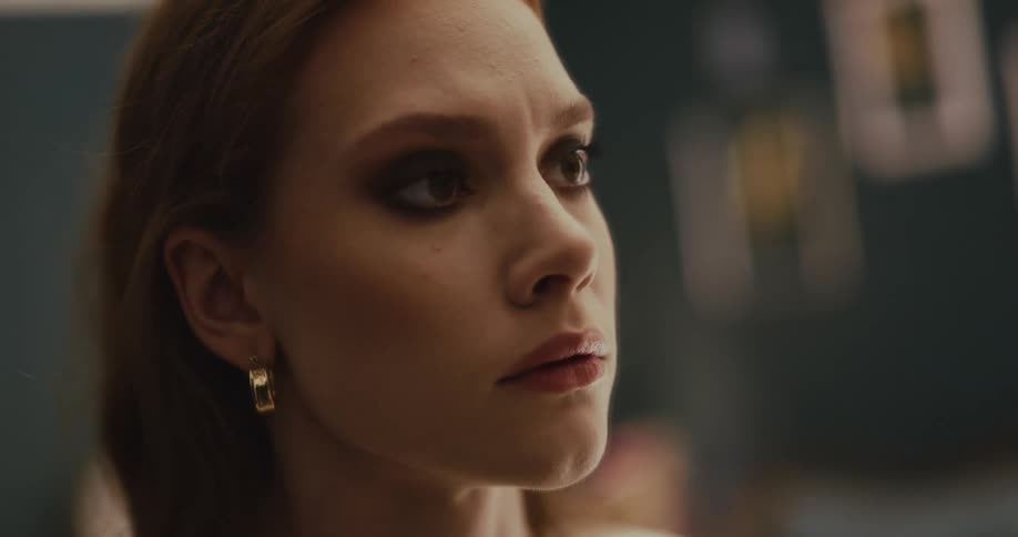 Two women stare intently at each other before one turns and leaves