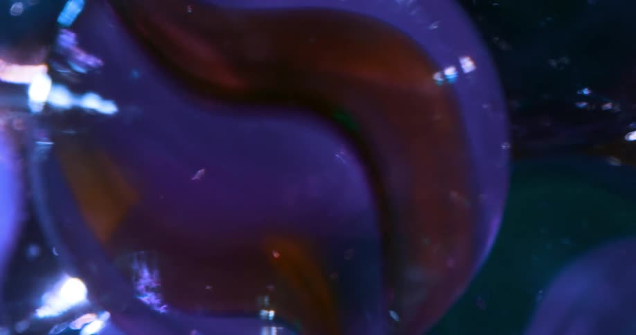 A container holding glass marbles spins around