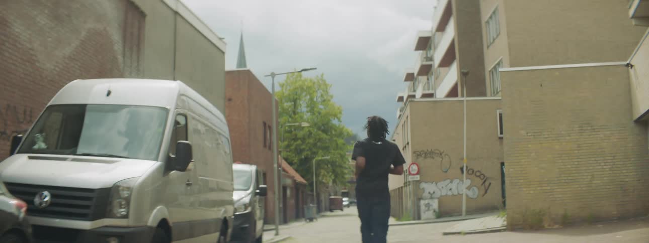A man running down a neighborhood street