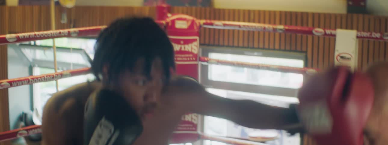 Two boxers fight in the ring