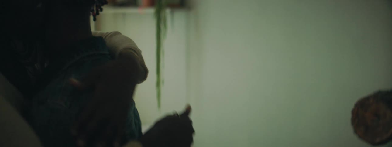 A woman greets a young man with a hug and smile and strokes his back